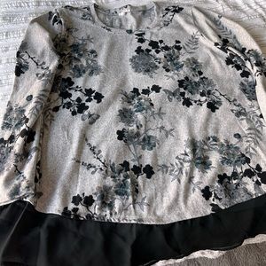 Gray tunic blouse with the black trim at the bottom.